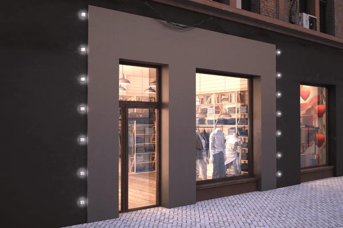 Fachada escura de loja com vitrines iluminadas